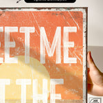 a person holding up a poster with the words get me out of the water