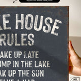 a hand holding a sign that says lake house rules