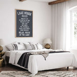 a bedroom with a large bed and a poster on the wall