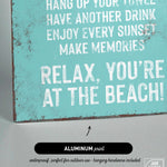 a blue sign that says relax you're at the beach