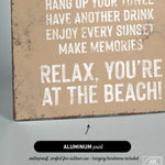 a sign that says relax you're at the beach