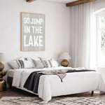 a bedroom with a white bed and a black and white rug