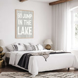 a bedroom with a white bed and a black and white rug