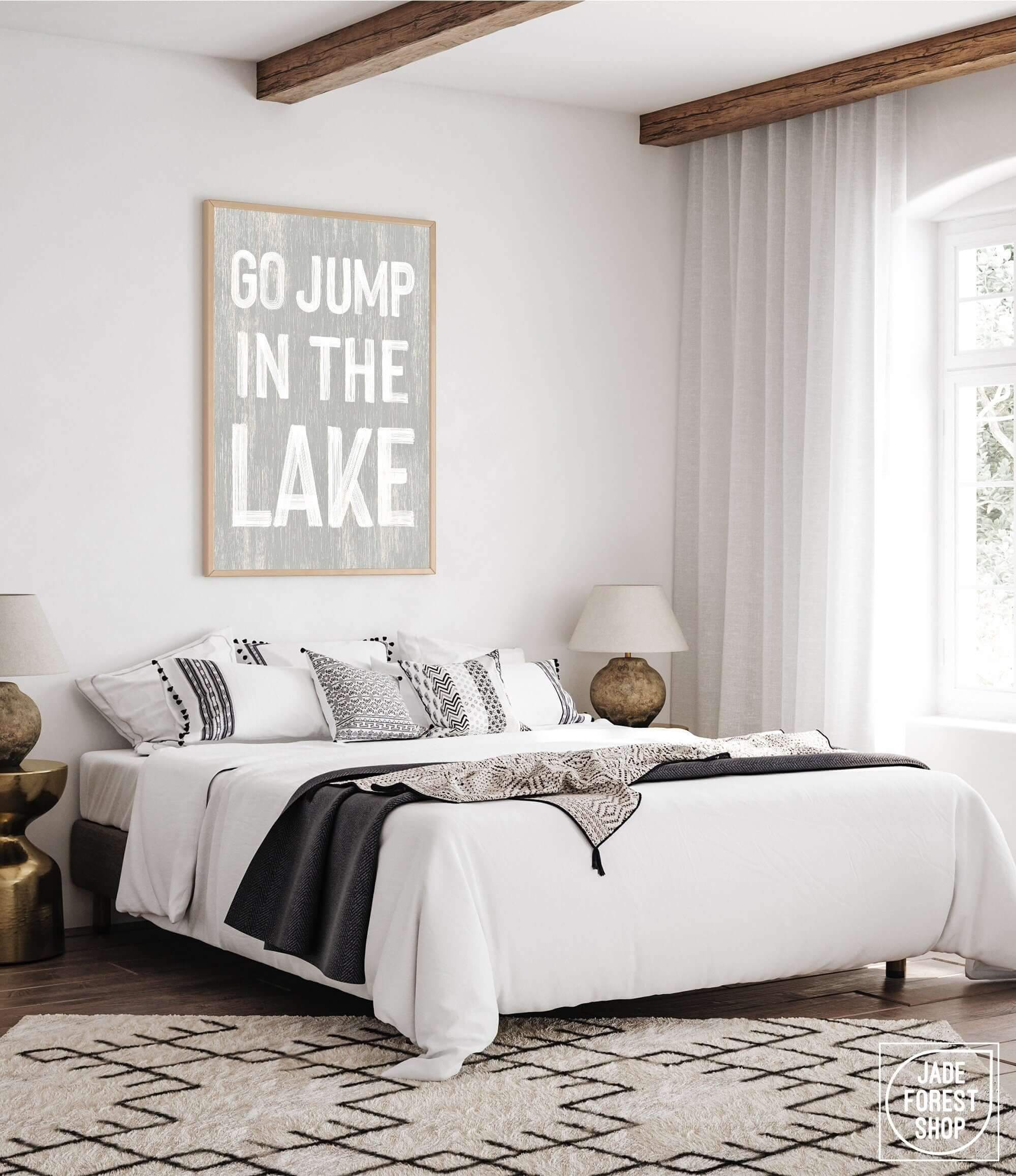 a bedroom with a white bed and a black and white rug