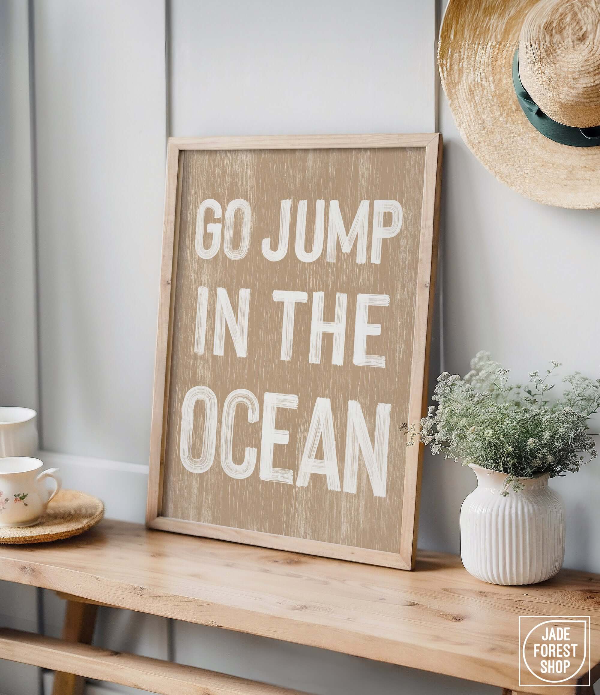 a wooden sign that says go jump in the ocean