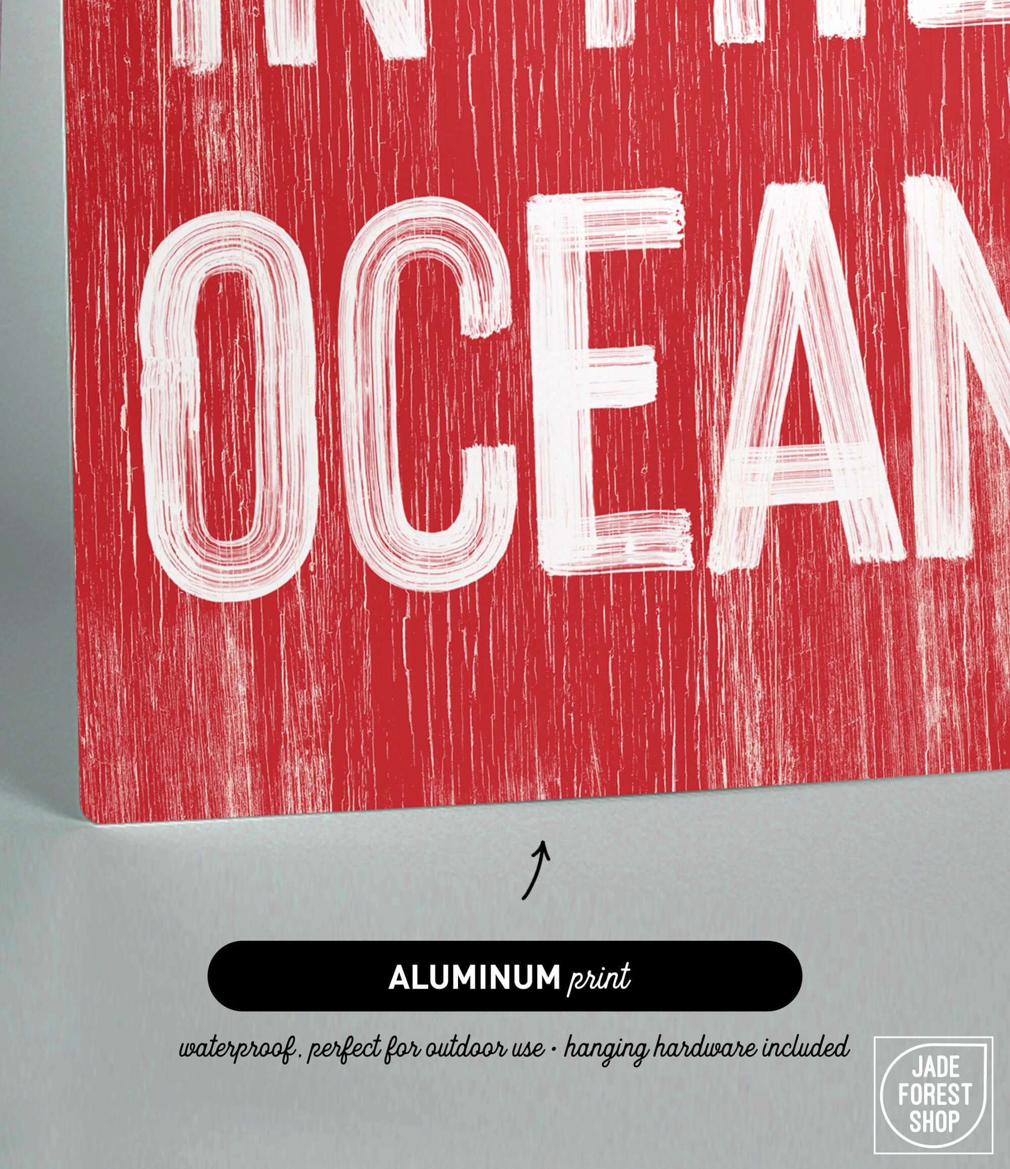 a red sign that says in the ocean