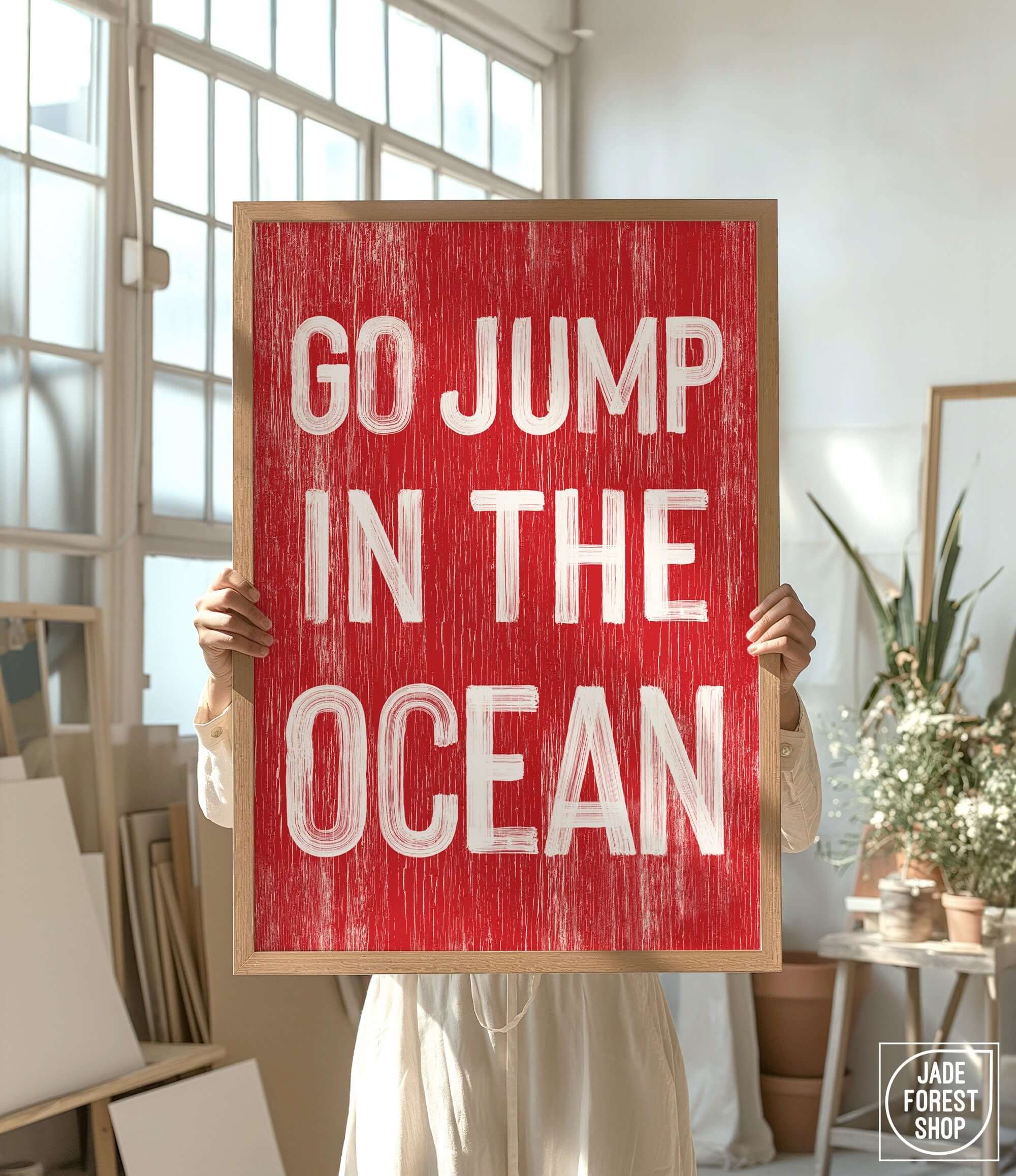 a woman holding a sign that says go jump in the ocean