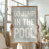 a person holding a sign that says go jump in the pool