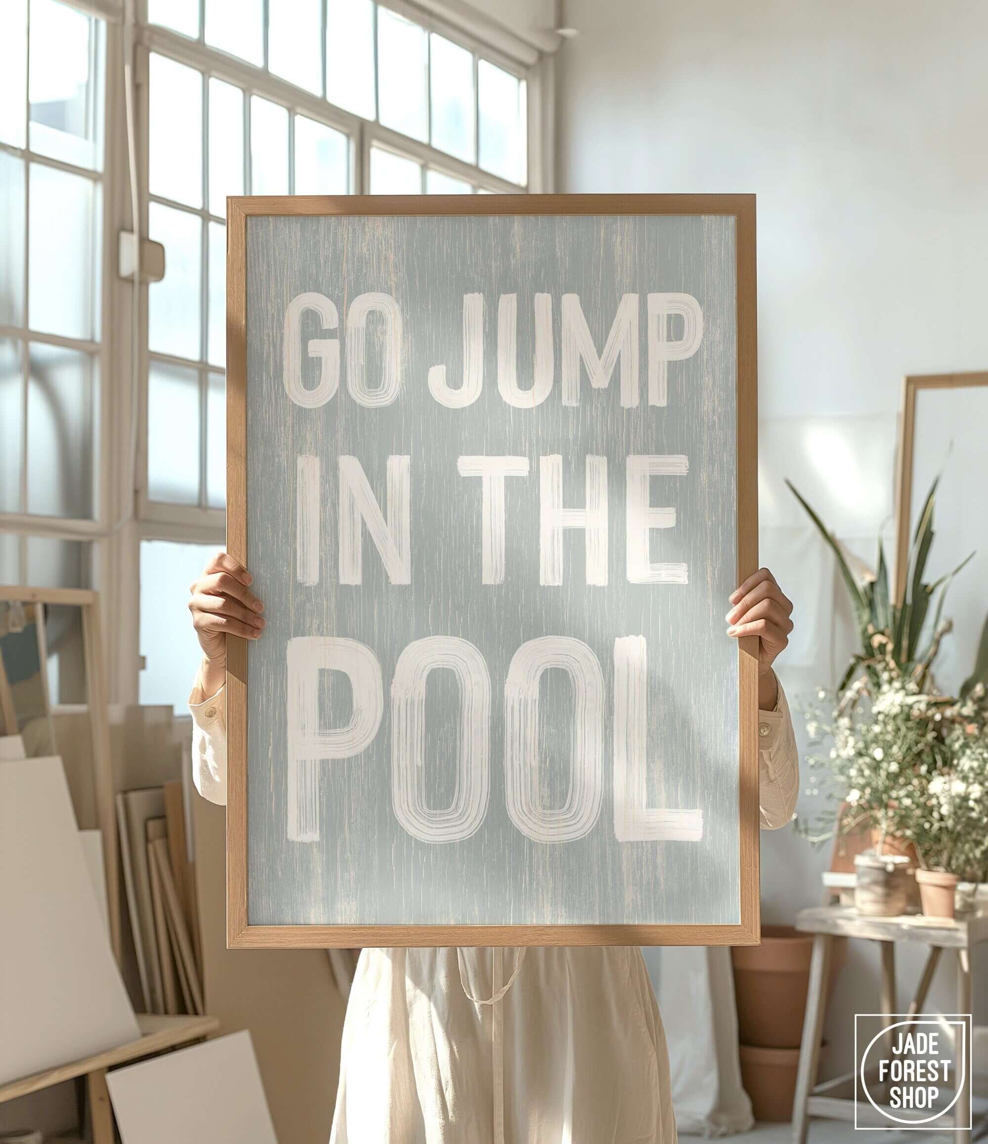 a person holding a sign that says go jump in the pool