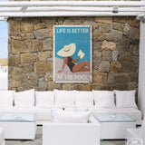 a living room with white furniture and a stone wall