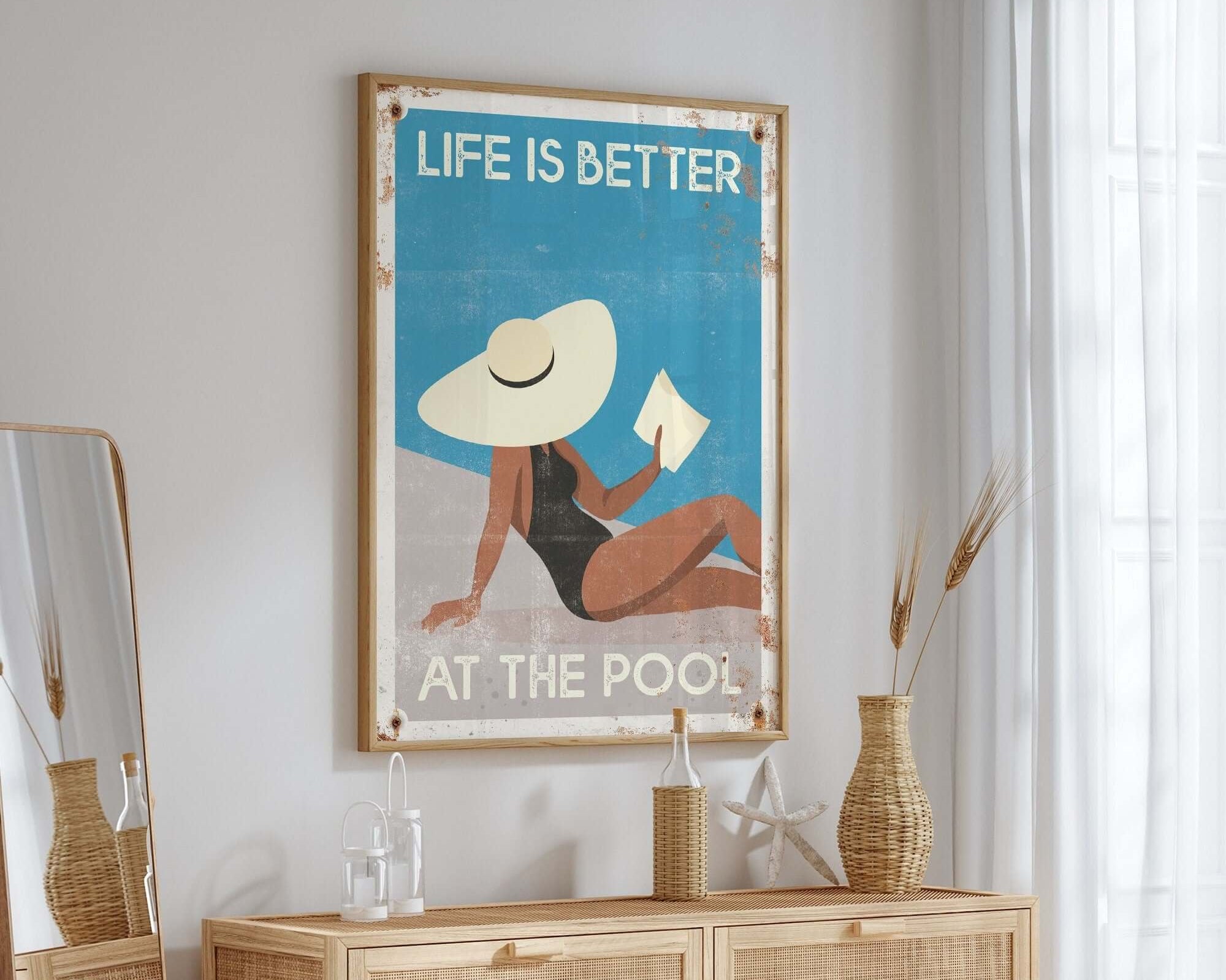a poster hangs on the wall above a dresser
