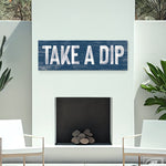 navy take a dip sign above outdoor white fireplace