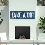 navy take a dip sign above outdoor white fireplace