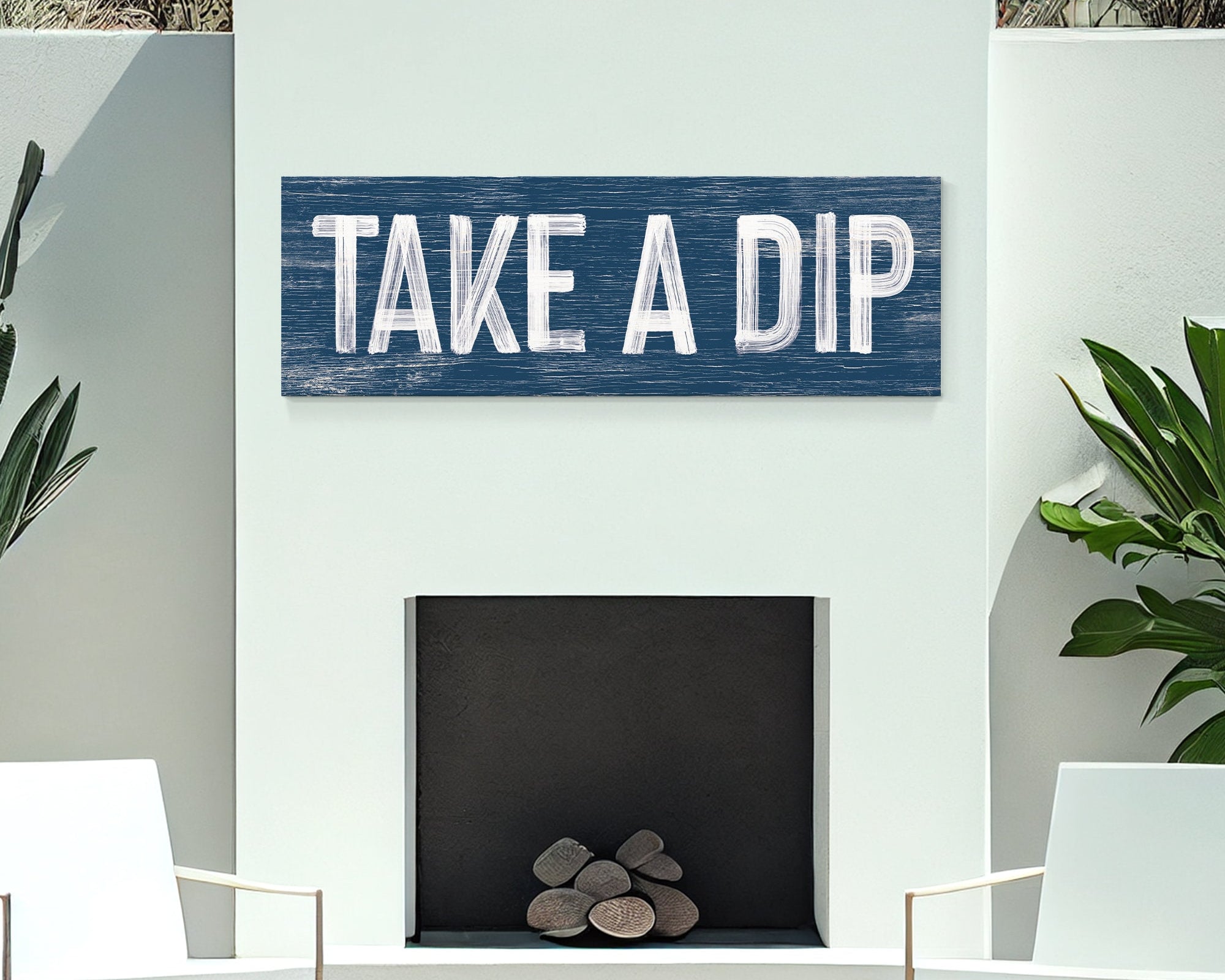 navy take a dip sign above outdoor white fireplace