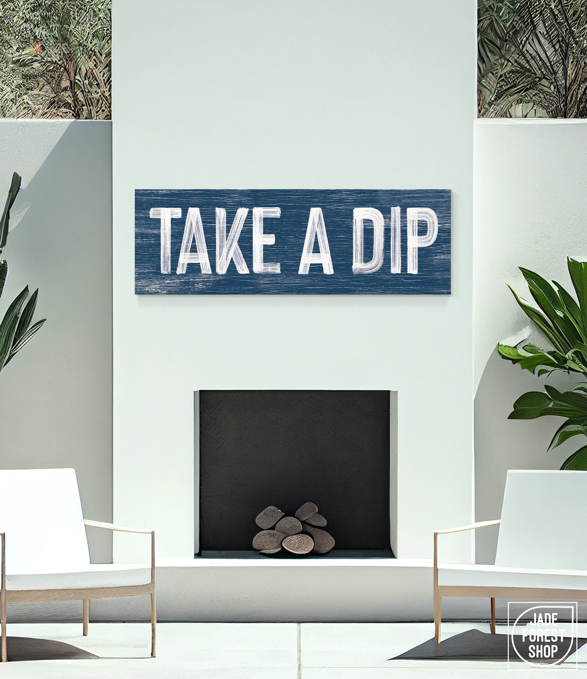 navy take a dip sign above outdoor white fireplace