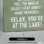 a sign that says relax you're at the lake