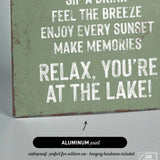 a sign that says relax you're at the lake