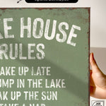 a hand holding a sign that says lake house rules