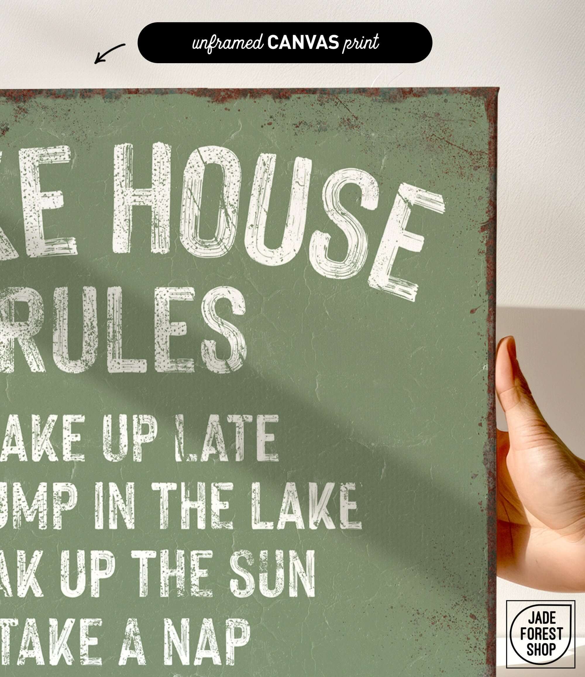 a hand holding a sign that says lake house rules