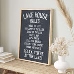 a sign that says lake house rules on a shelf