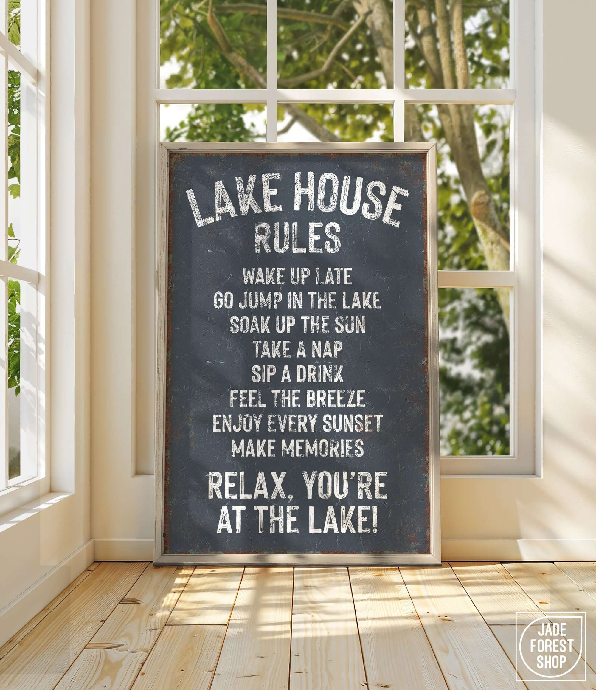 a sign on a wooden floor in front of a window
