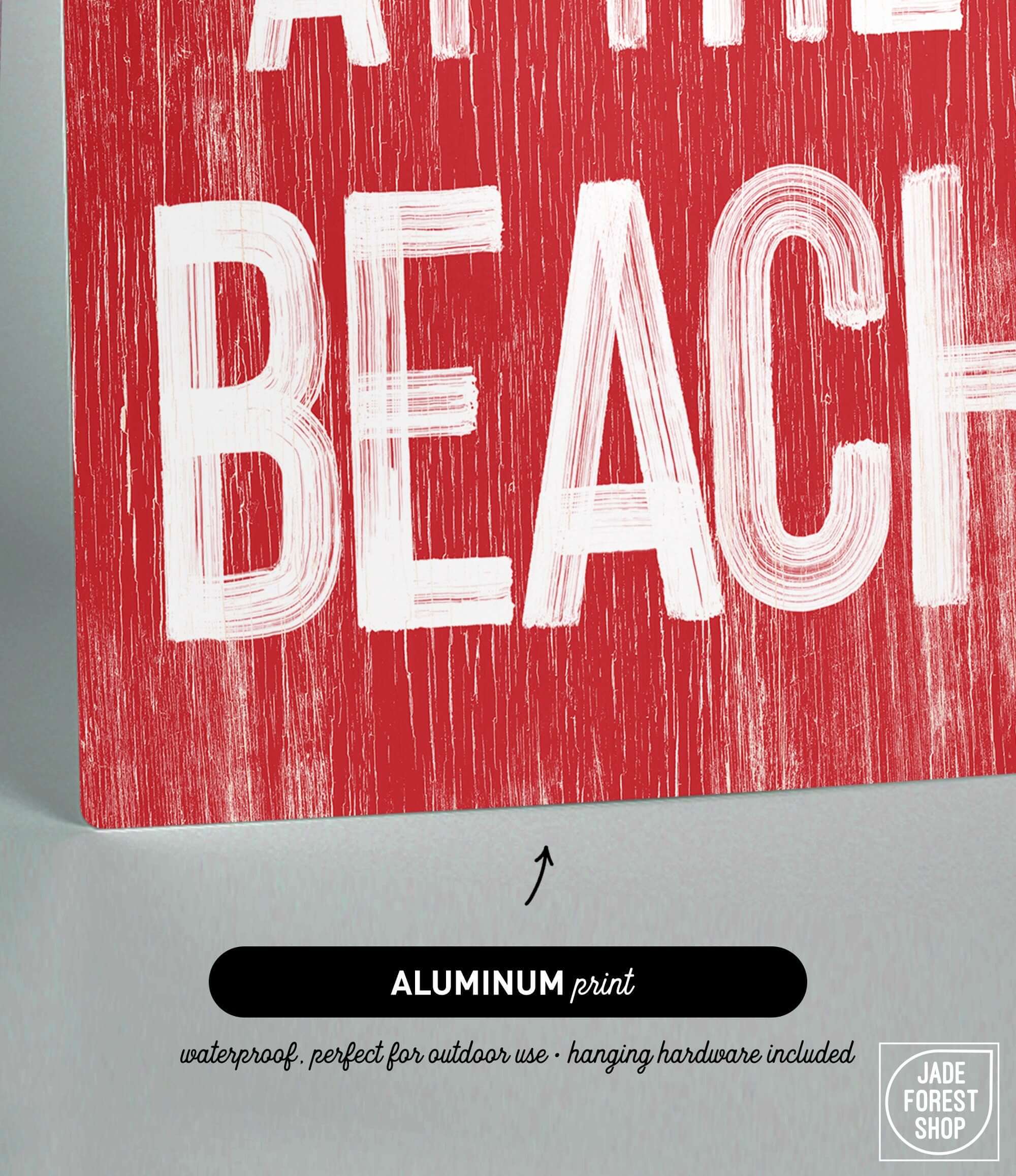 a red and white sign that says at the beach