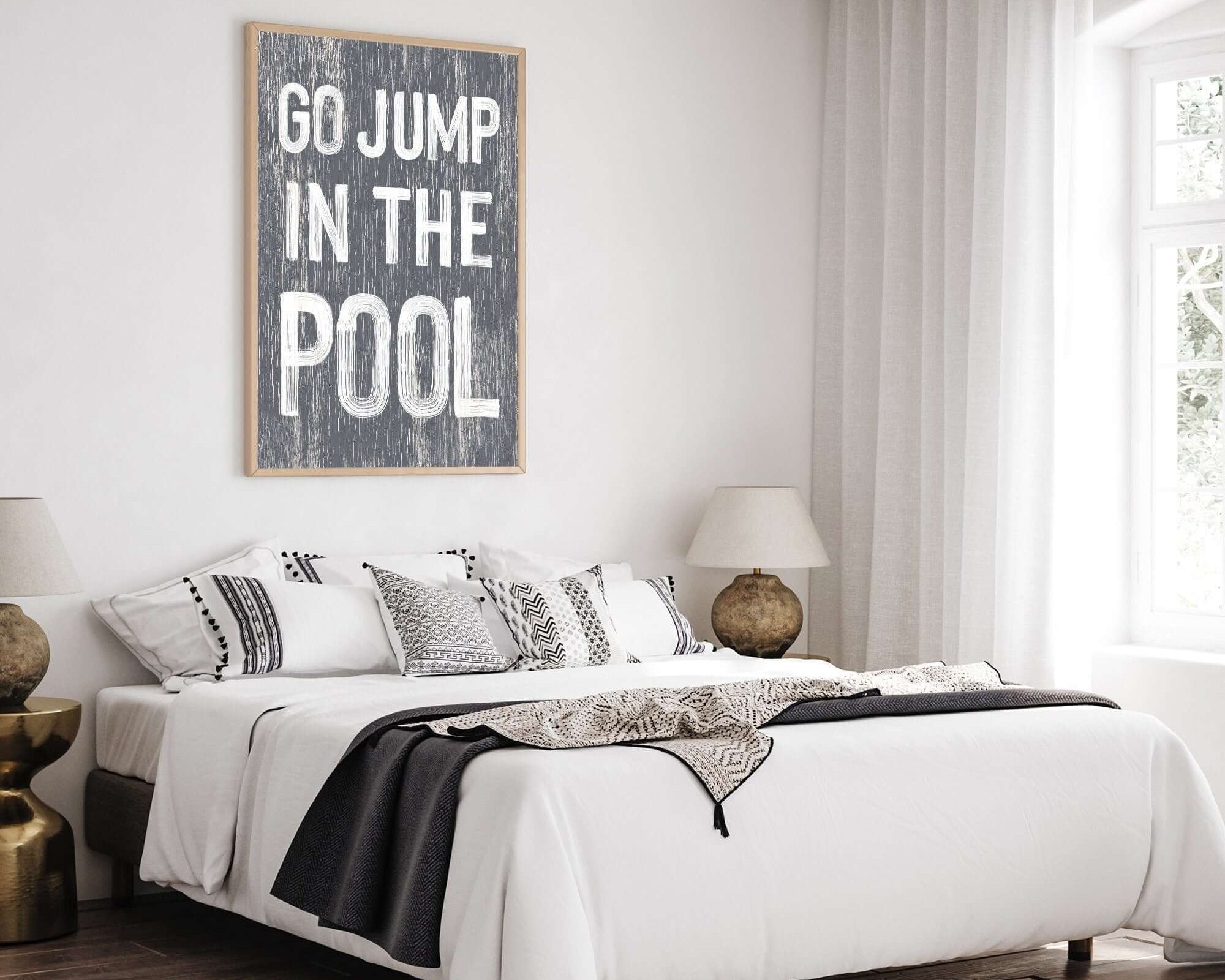 a bedroom with a white bed and a black and white rug