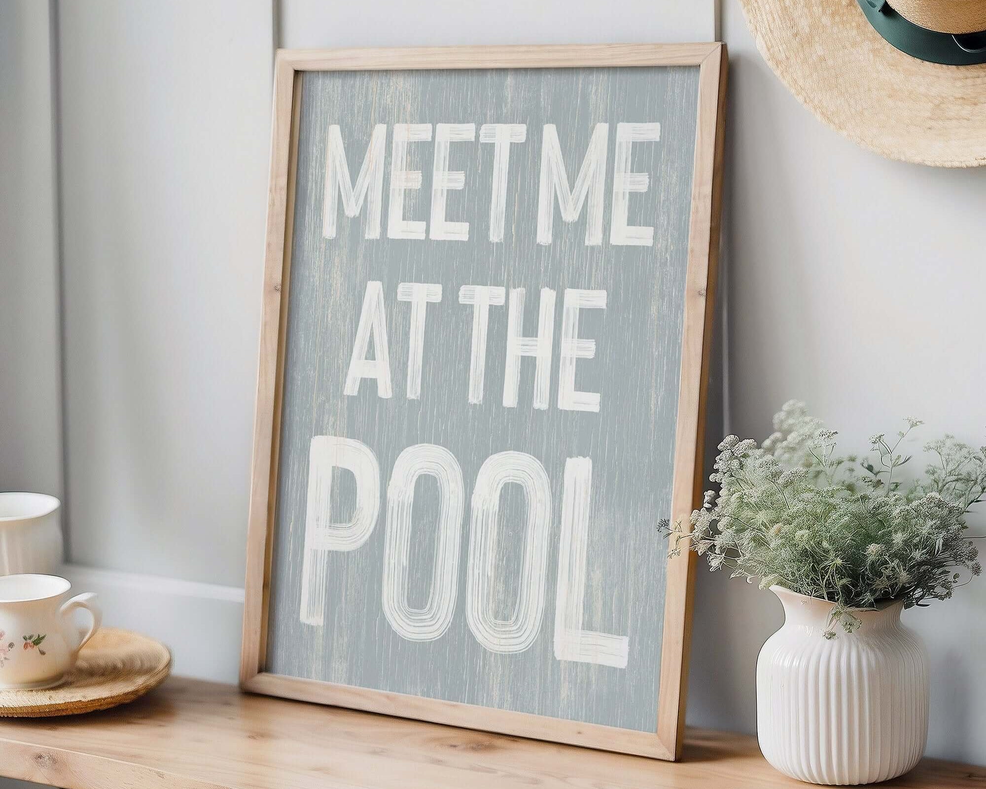 A Meet Me at the Pool Sign, Smoke, sits framed on a wooden bench with modern farmhouse decor—nearby plants and teacups lend extra charm.