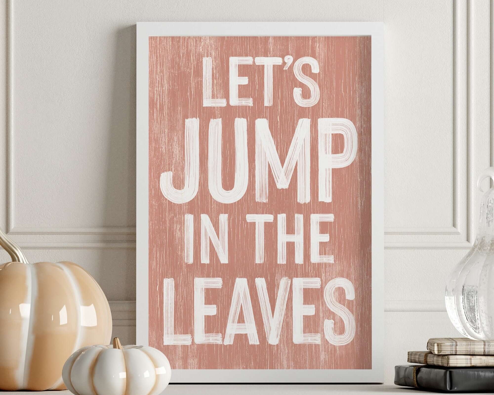 a picture of a pink poster that says let's jump in the leaves