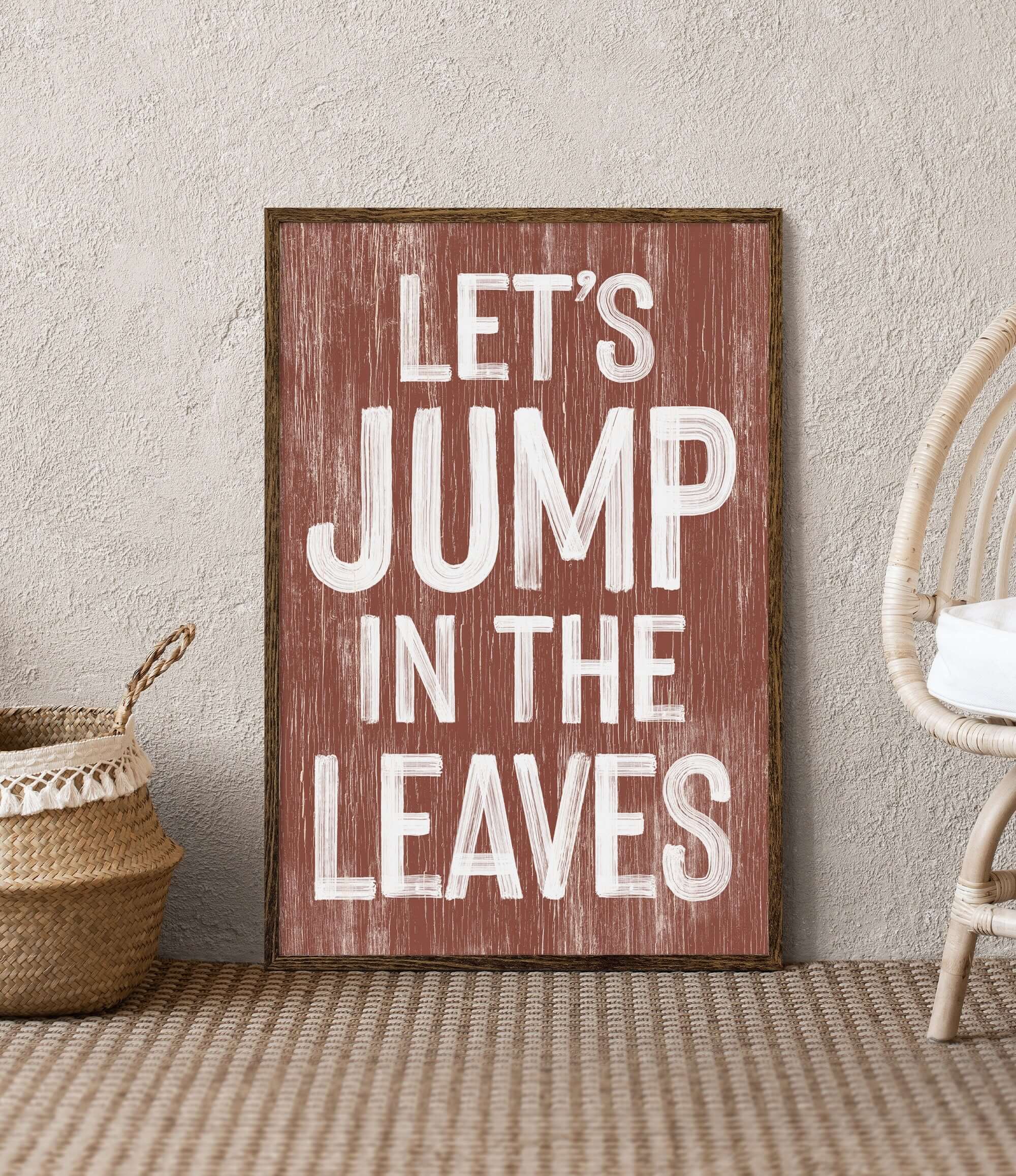 a wooden sign that says let's jump in the leaves