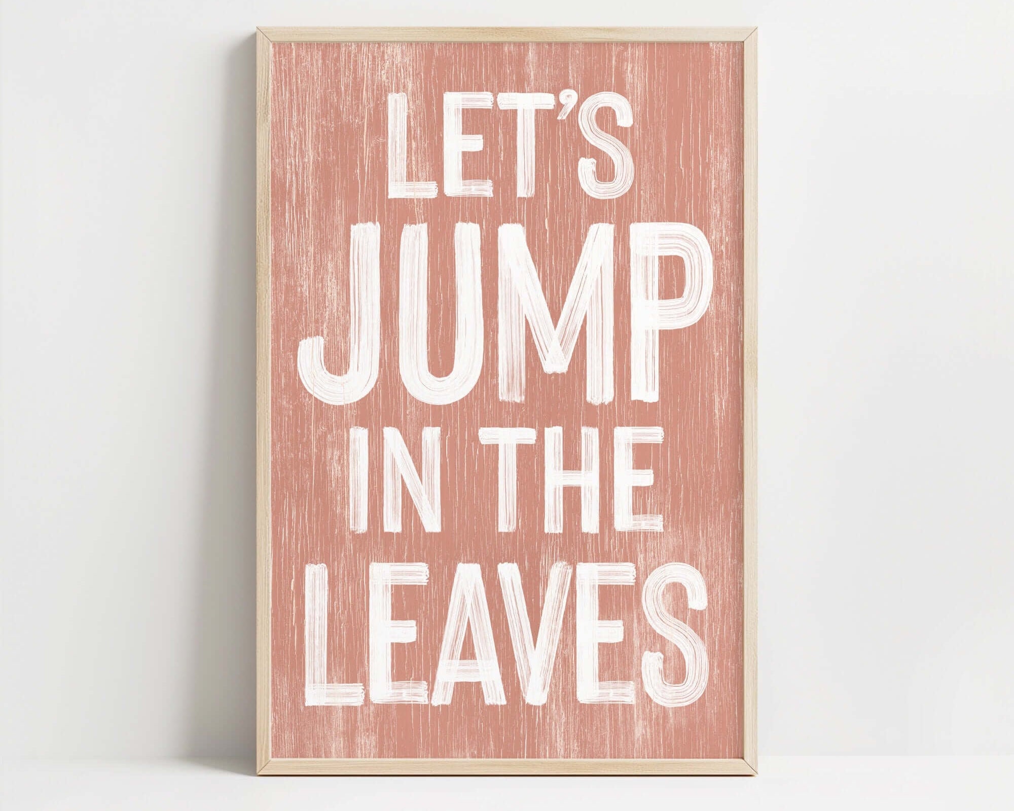 a wooden sign that says let's jump in the leaves