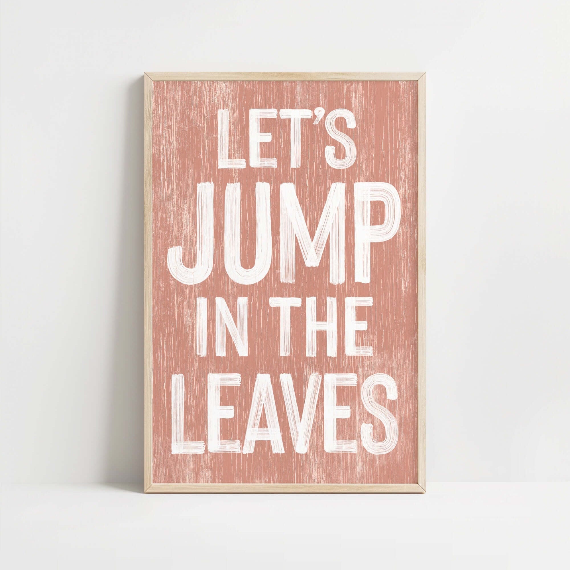 a wooden sign that says let's jump in the leaves