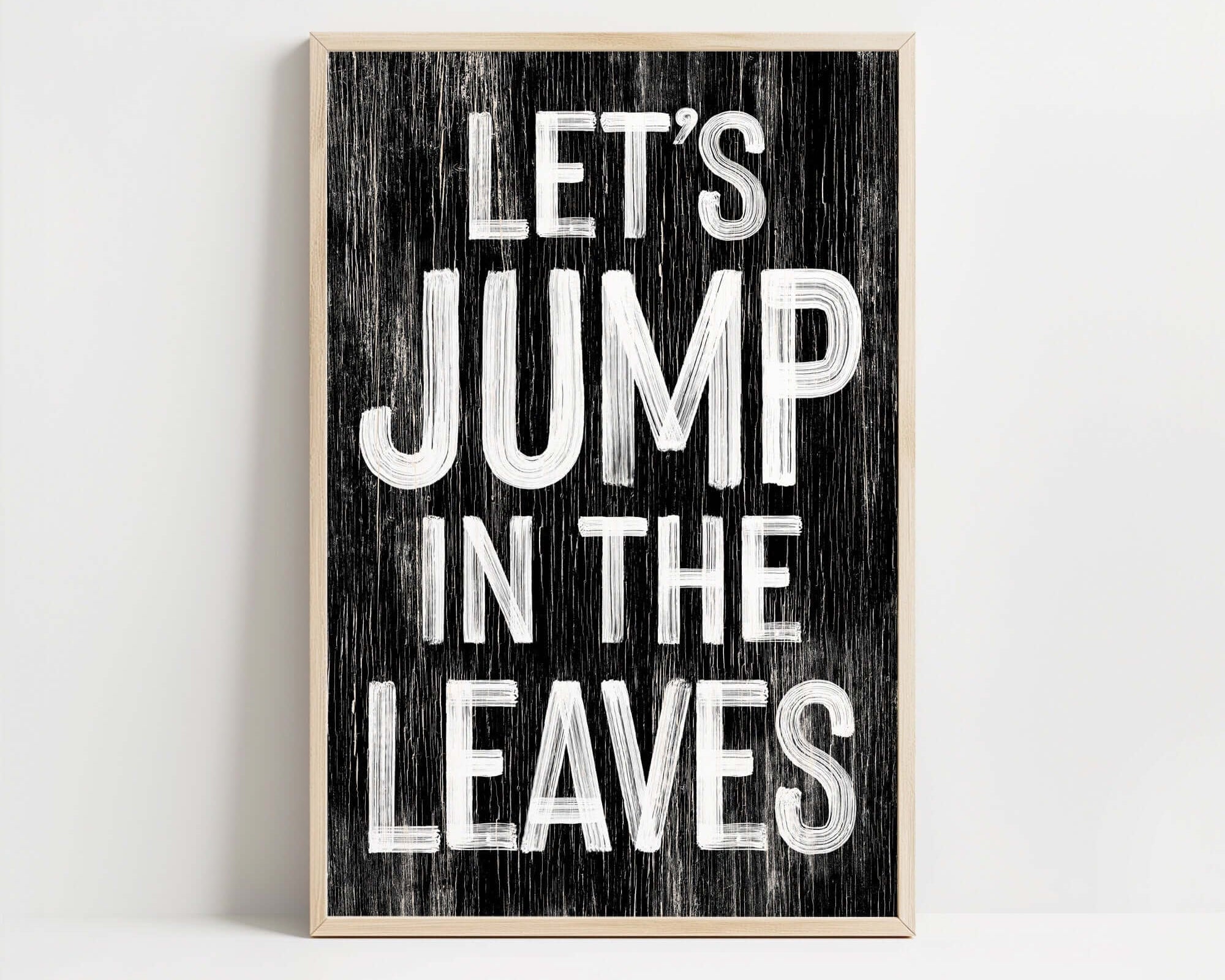 a wooden sign that says let's jump in the leaves