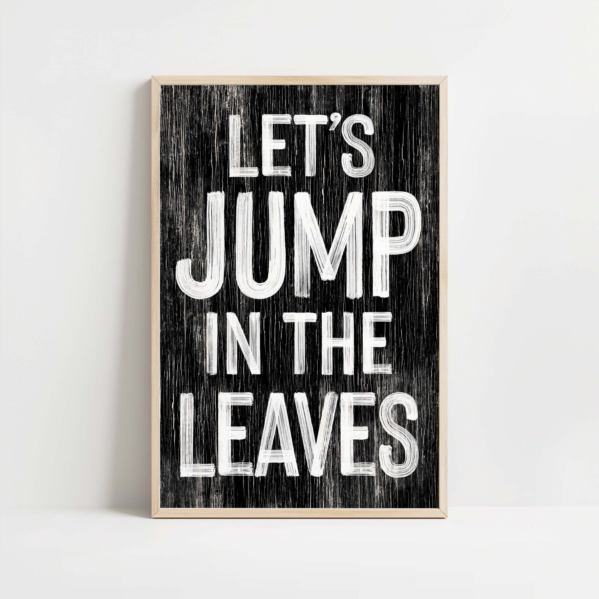 a wooden sign that says let's jump in the leaves