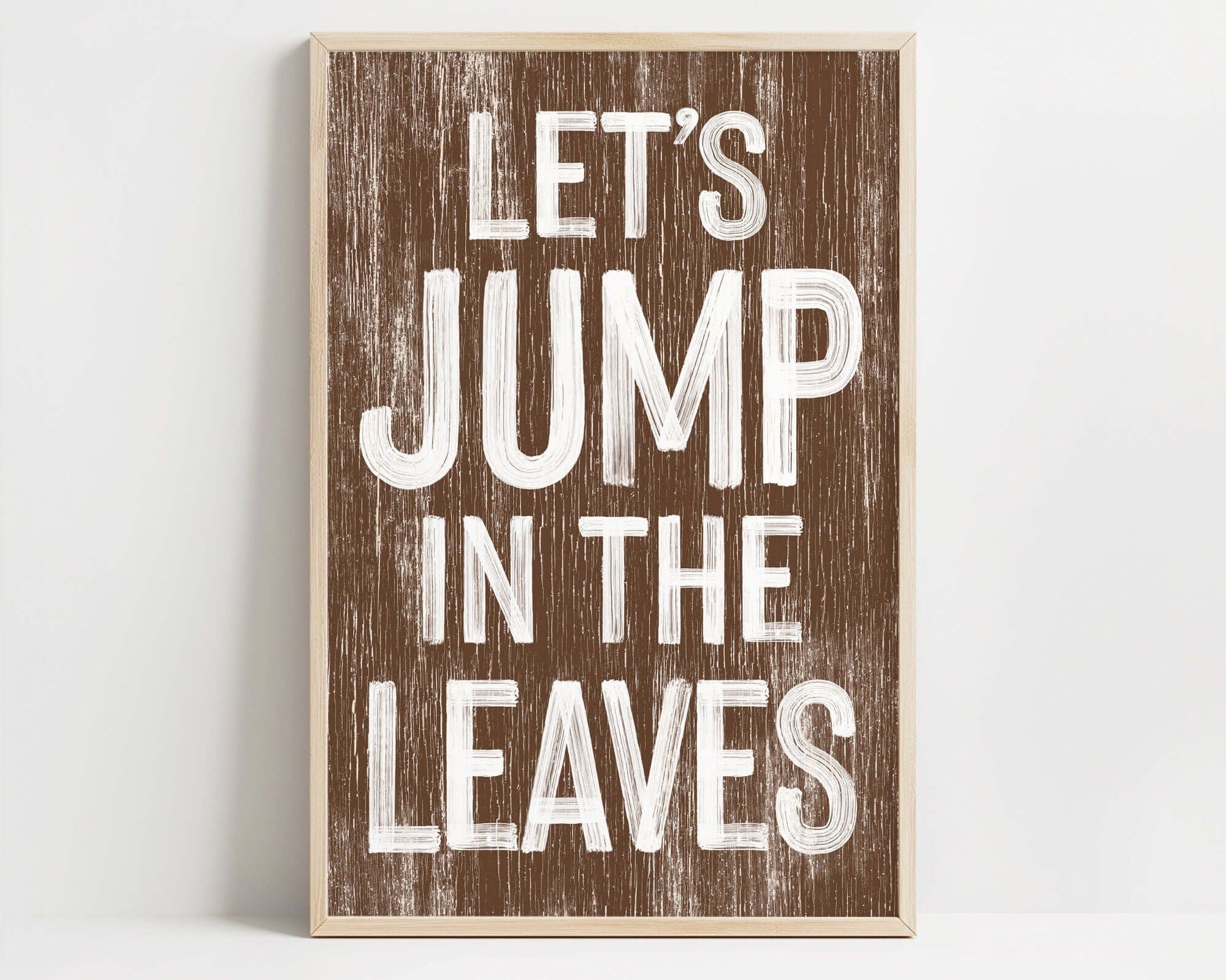 a wooden sign that says let's jump in the leaves