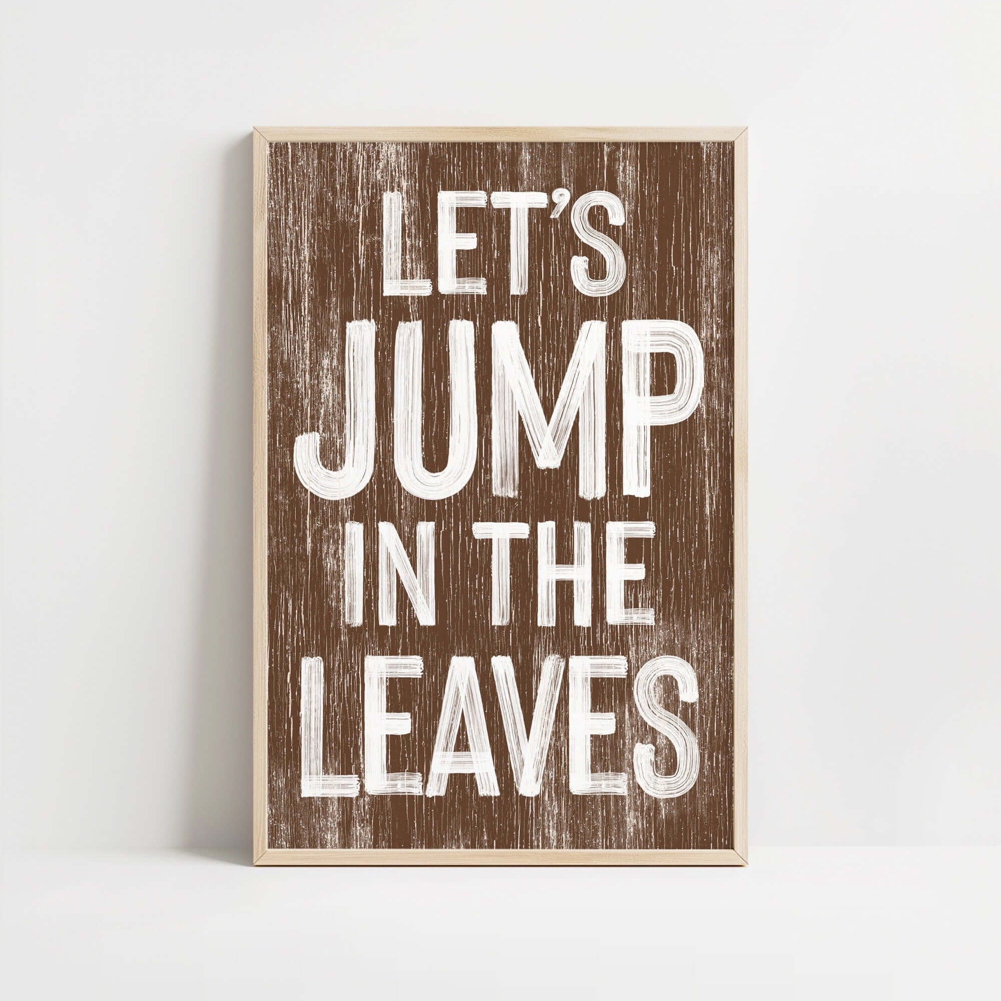 a wooden sign that says let's jump in the leaves