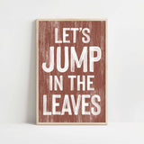 a wooden sign that says let's jump in the leaves