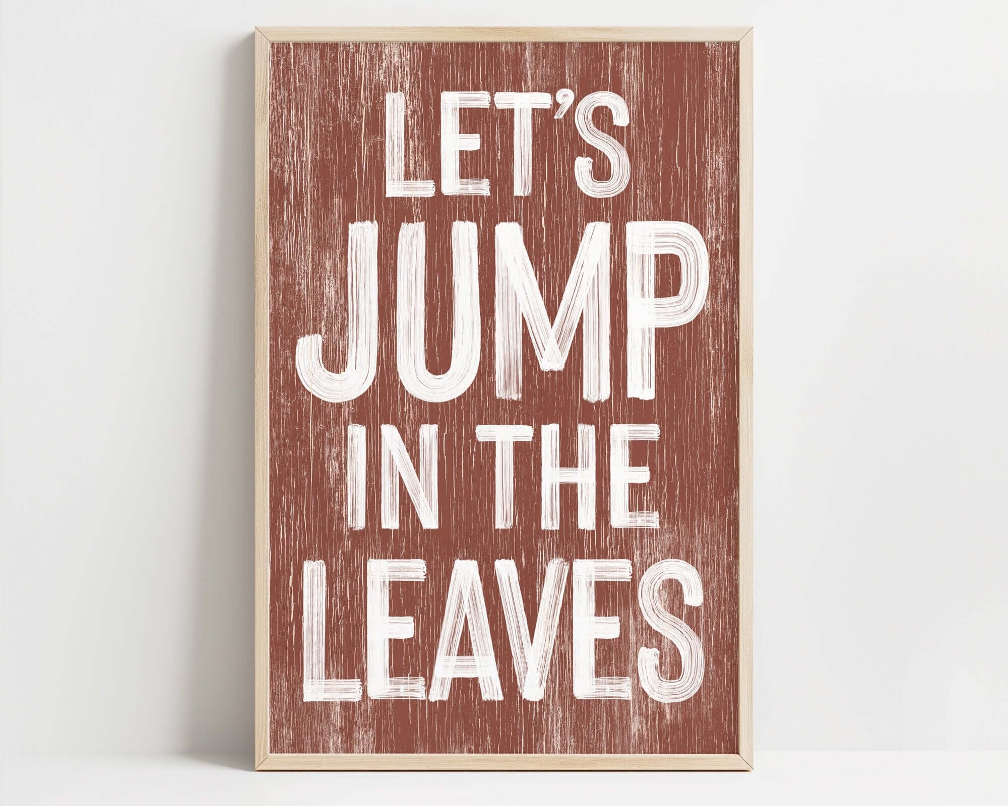 a wooden sign that says let's jump in the leaves