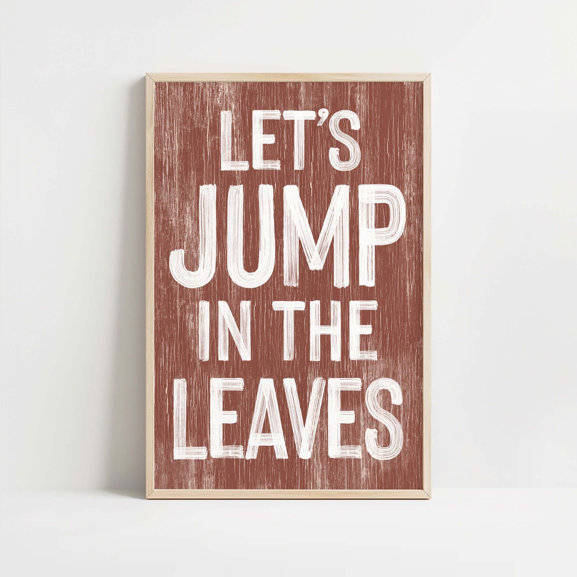 a wooden sign that says let's jump in the leaves