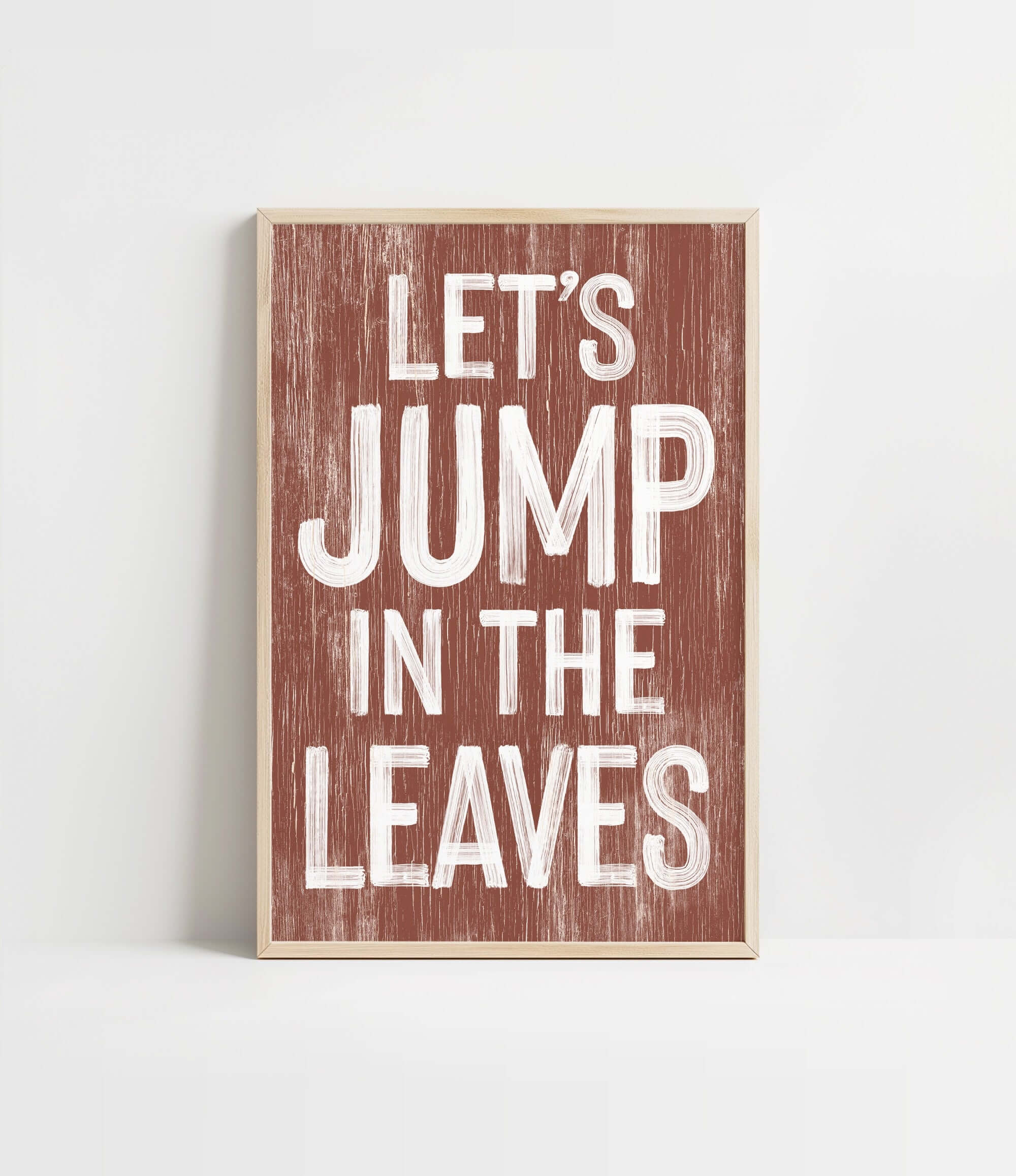 a wooden sign that says let's jump in the leaves