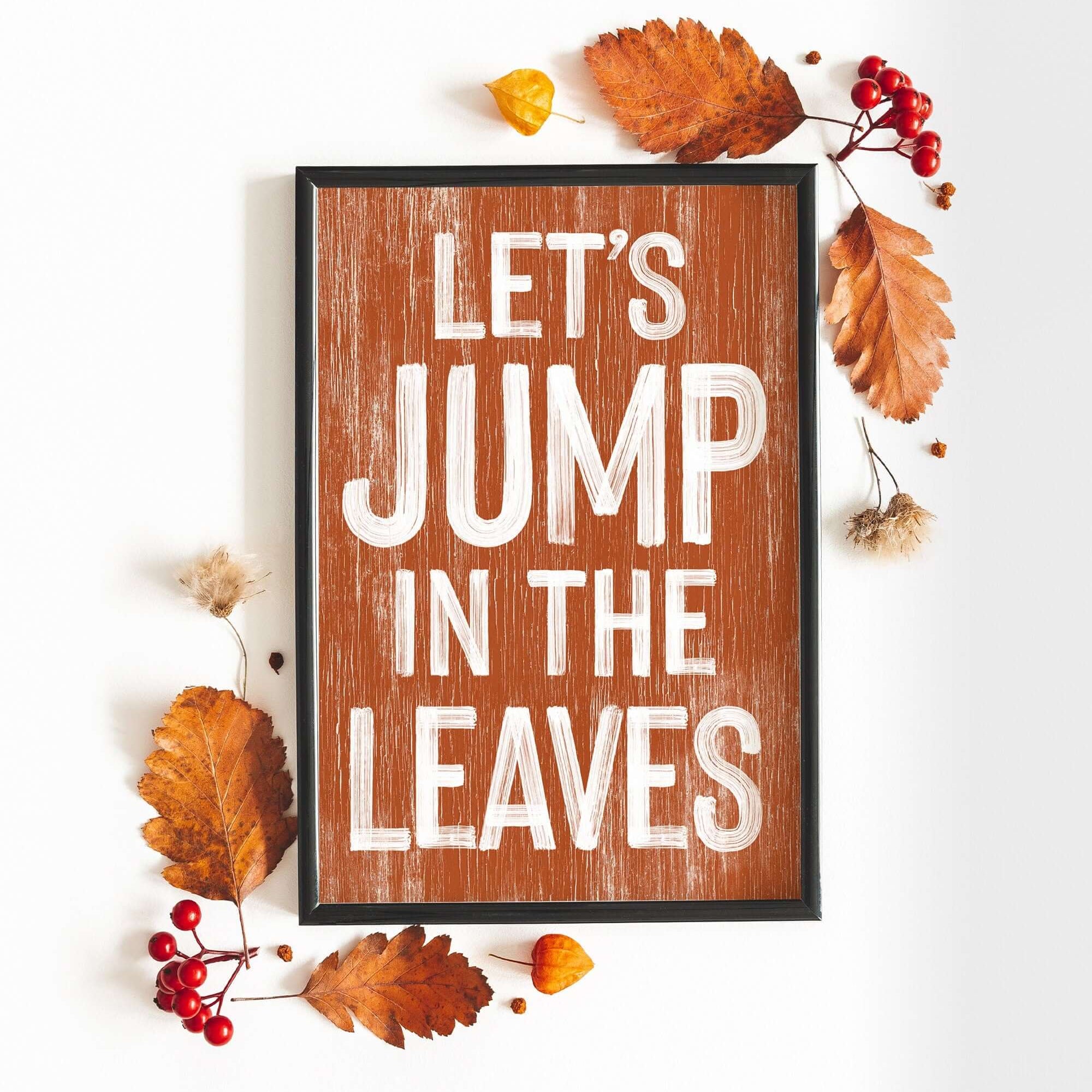 a wooden sign that says let's jump in the leaves