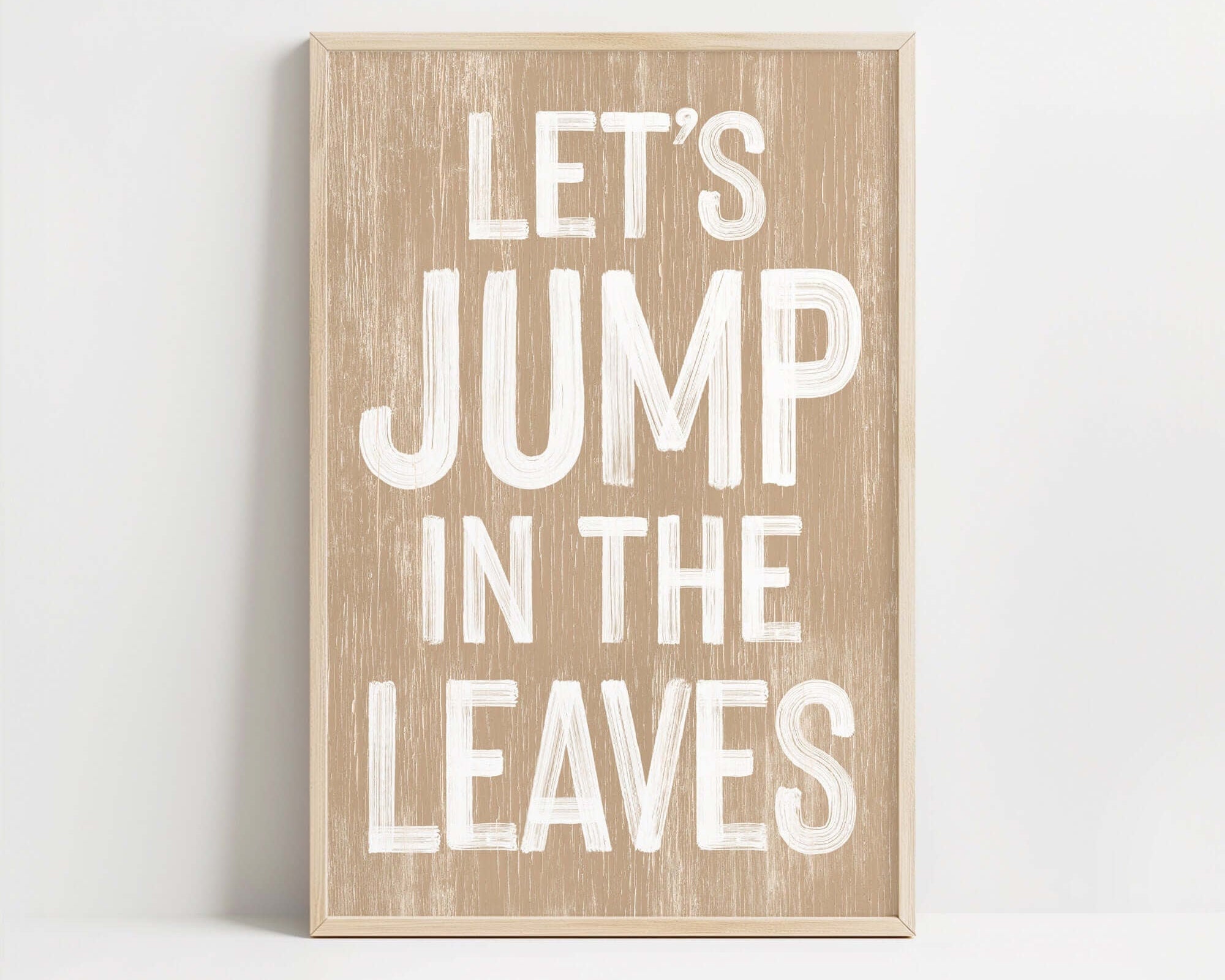 a wooden sign that says let's jump in the leaves