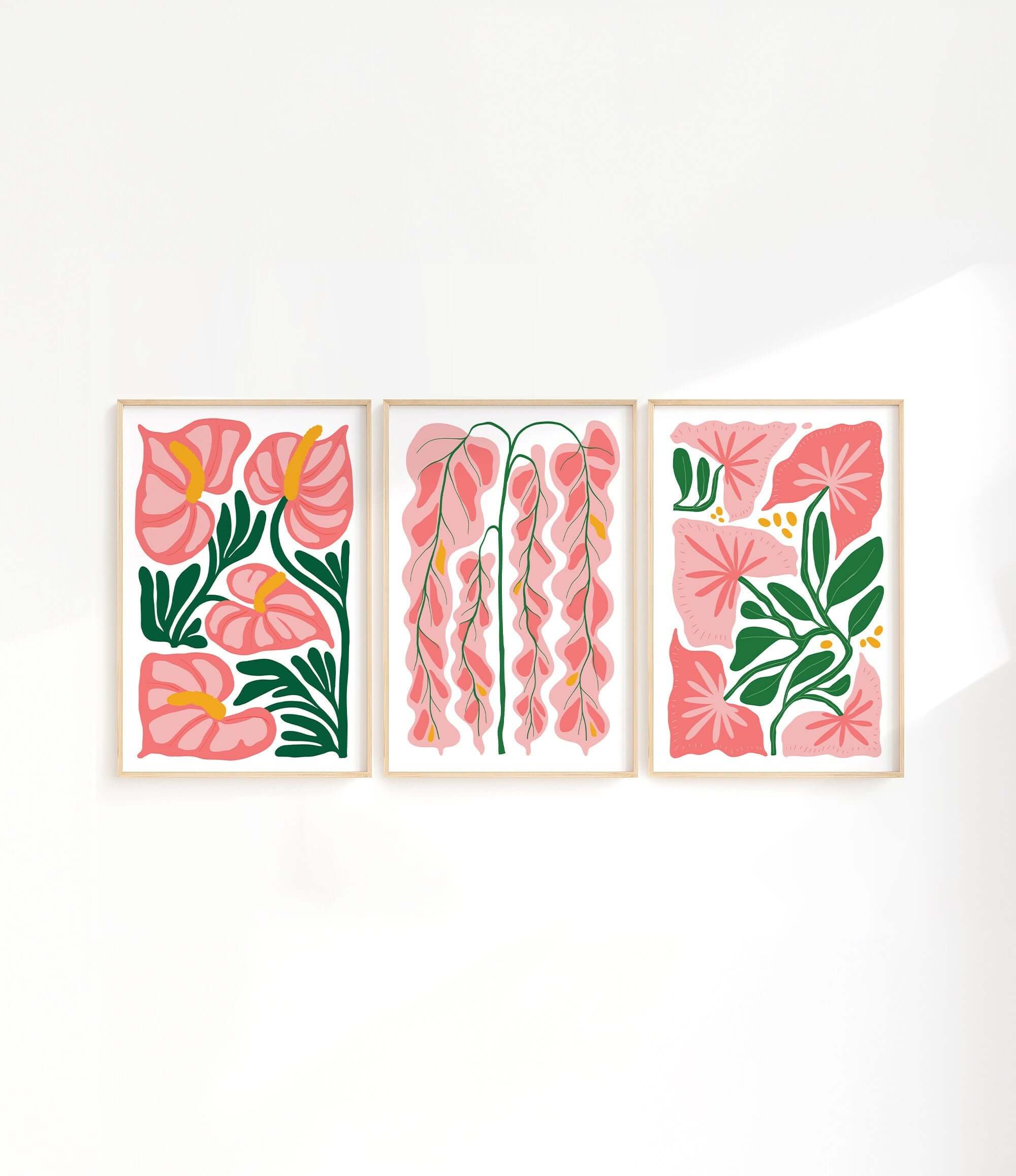 three paintings of pink flowers on a white wall