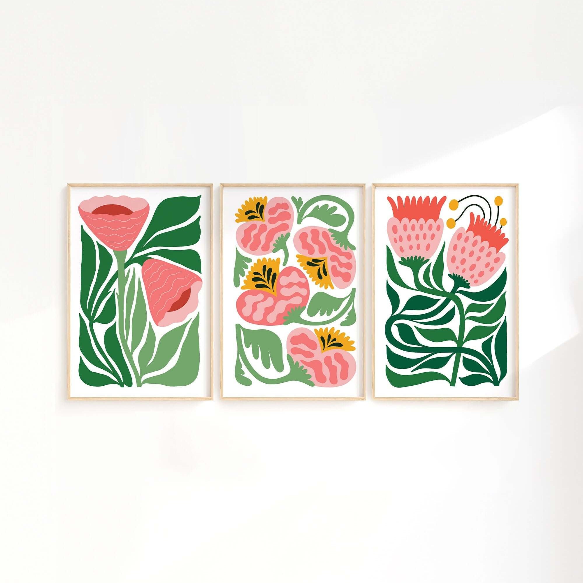 The Tropical Blocks Triptych (Set of Three Prints | 406) features abstract floral designs with green leaves and pink flowers, ideal for adding style and elegance to your home decor.