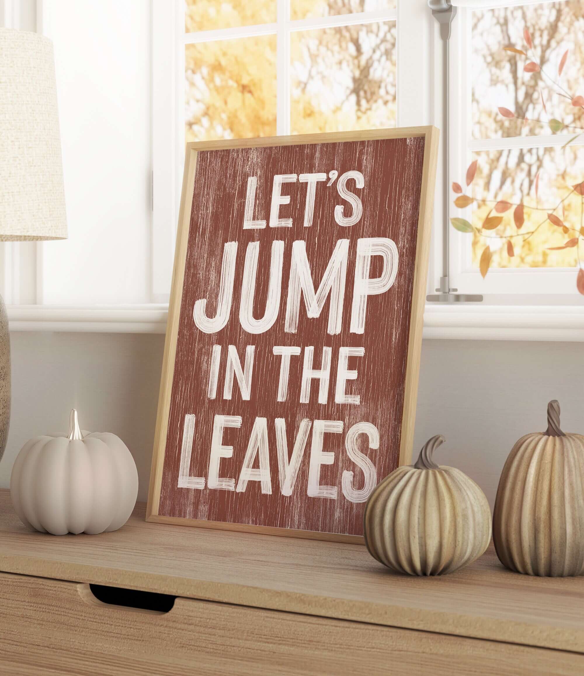 a wooden sign that says let's jump in the leaves