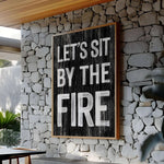 a sign that reads let's sit by the fire