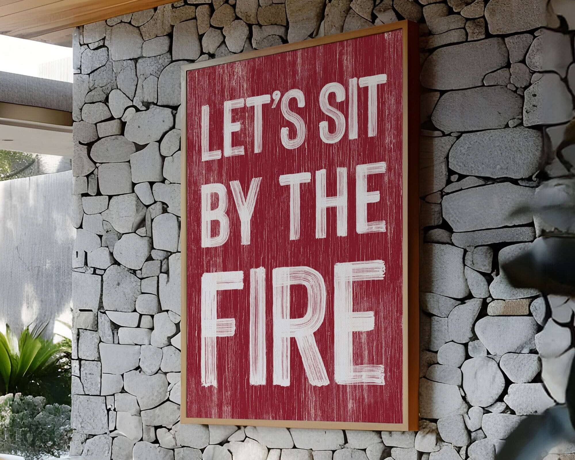 a red sign that says let's sit by the fire
