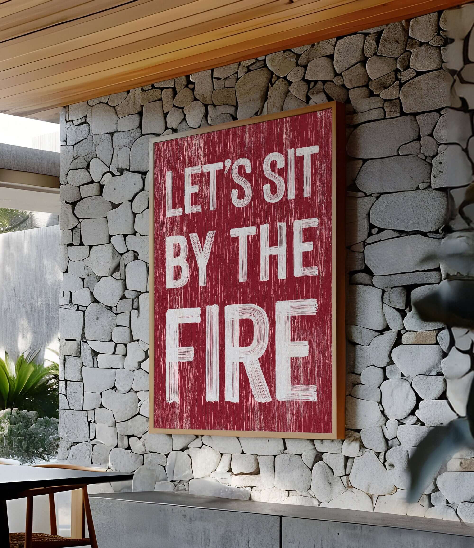 a red sign that says let's sit by the fire