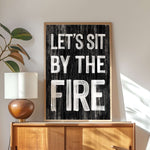 a black and white sign that says let's sit by the fire