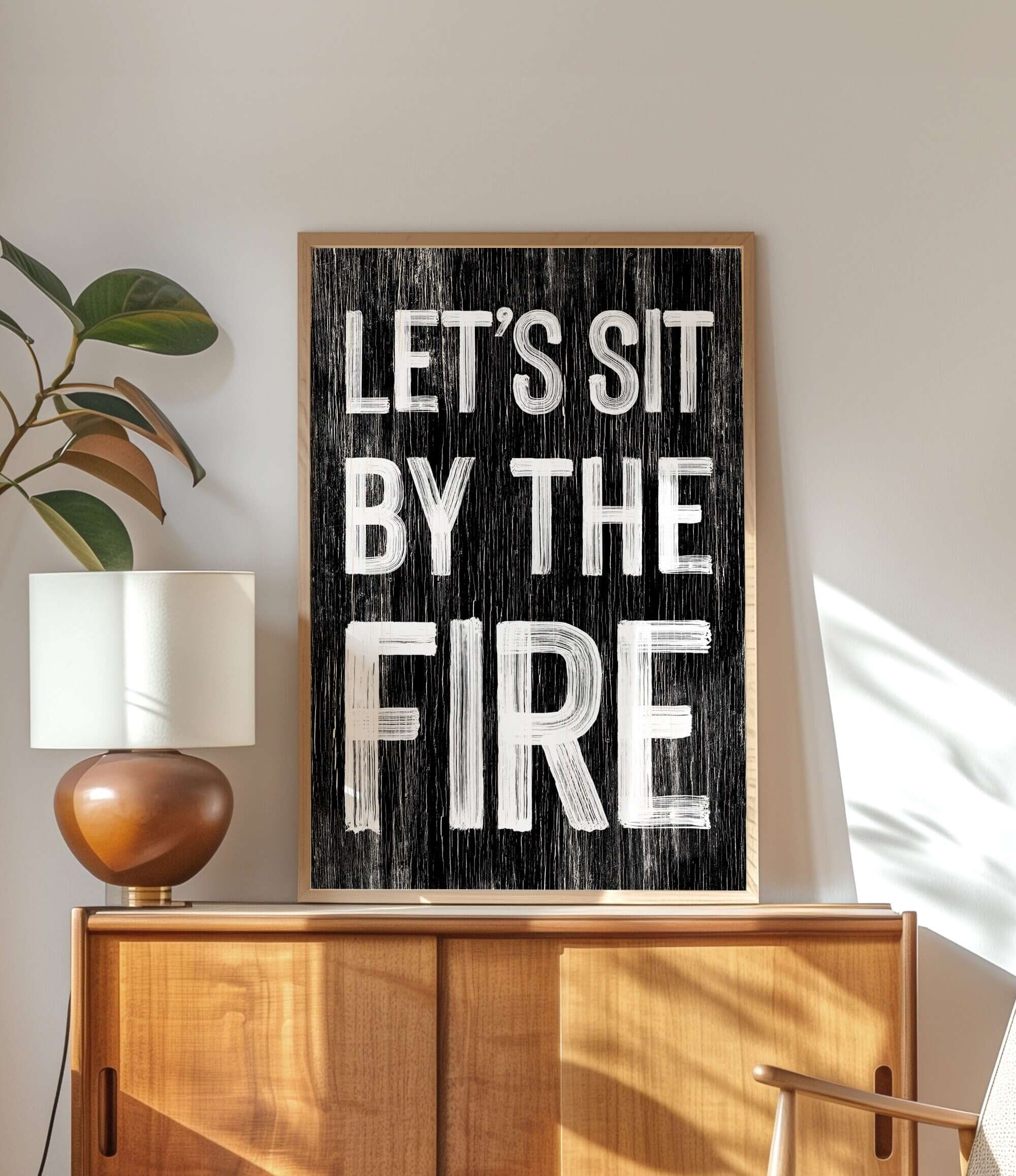 a black and white sign that says let's sit by the fire